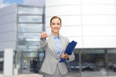 smiling businesswoman with folder and keys